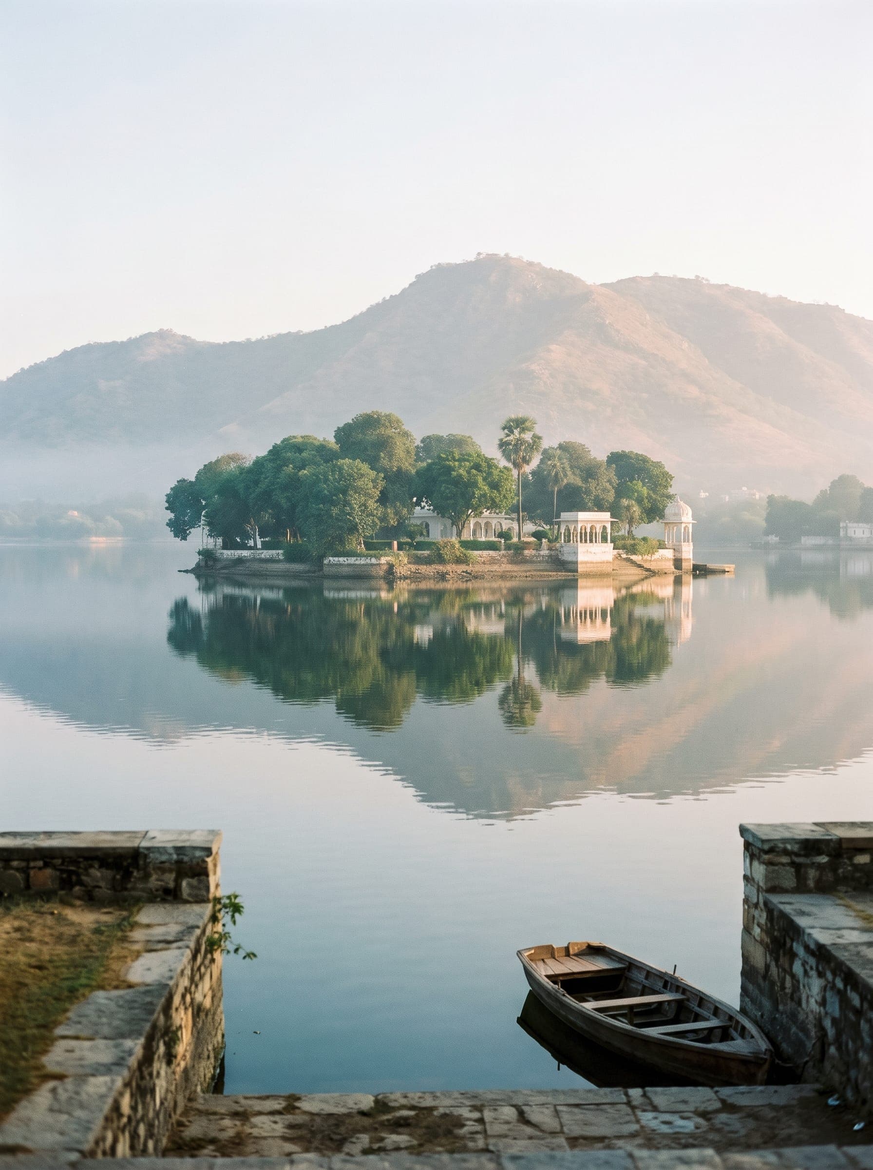 Fateh Sagar lake with hills behind on a calm morning